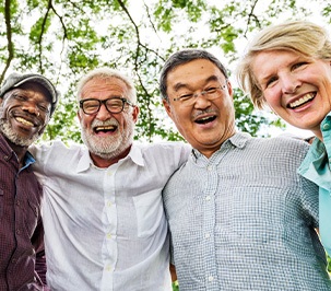 Patients in Marysville smiling happily together after getting dentures
