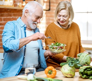 Senior patient in Marysville enjoying a healthy meal after getting dentures