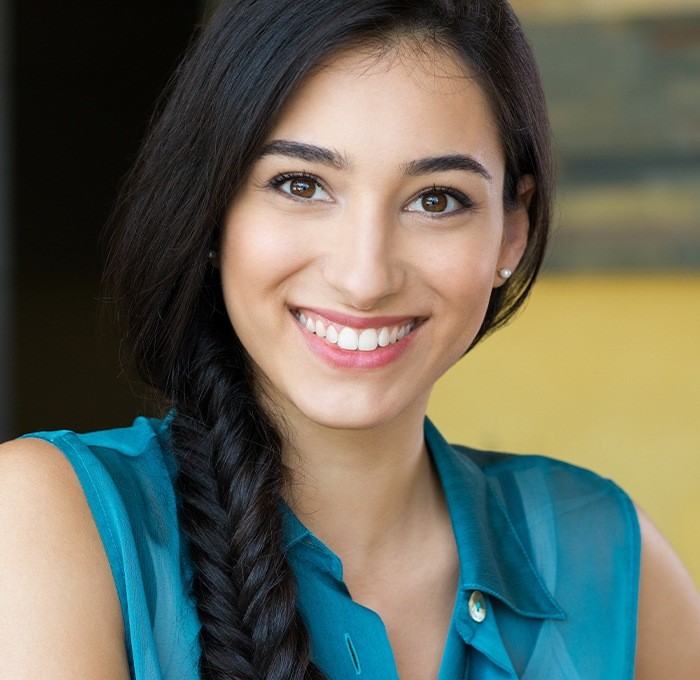 woman in green shirt smiling