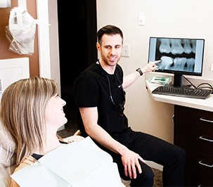 dentist showing patient x-rays