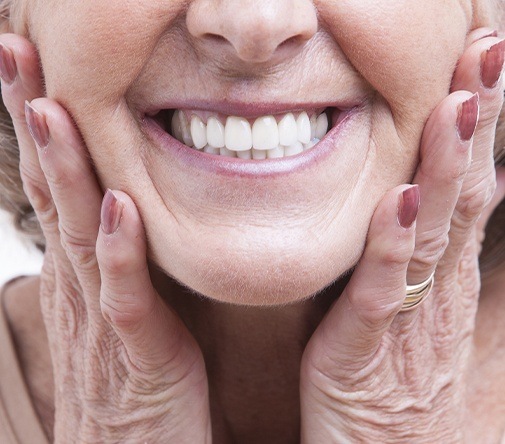 woman holding both cheeks with both hands