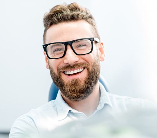 man with beard and glasses smiling