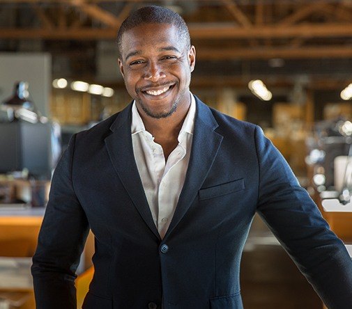 man in fancy black suit smiling