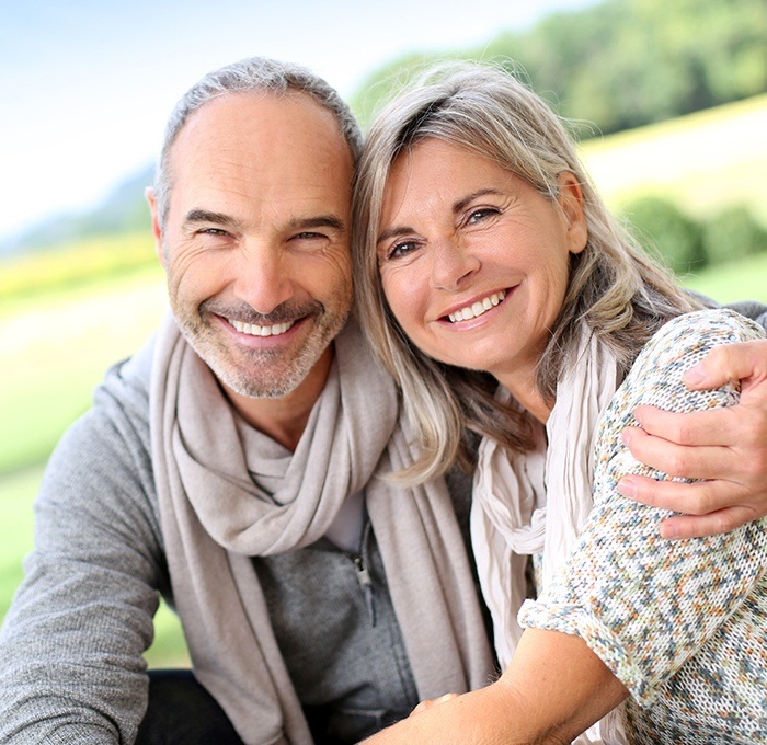 husband and wife smiling with scarfs on