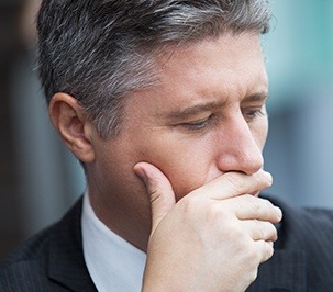 man covering mouth with hand