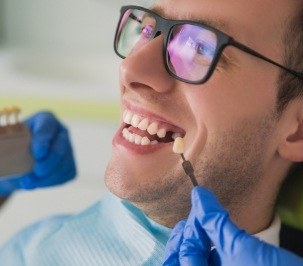 man being fitted for color match where missing tooth is