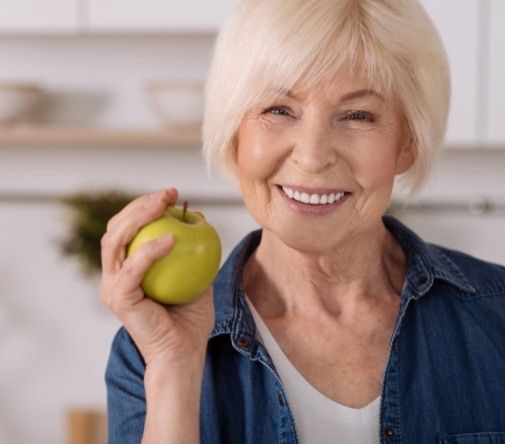 woman holding green apple