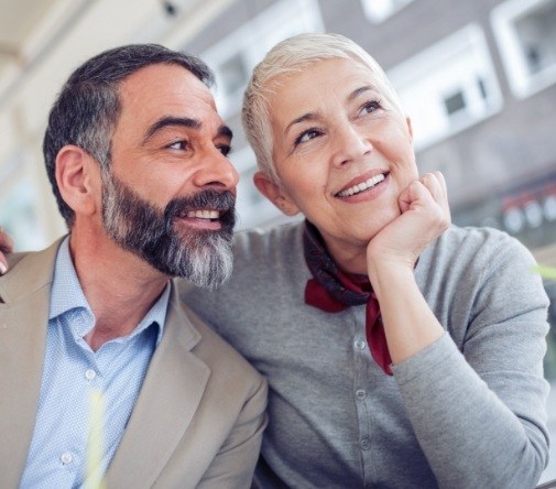 man and woman smiling off in distance