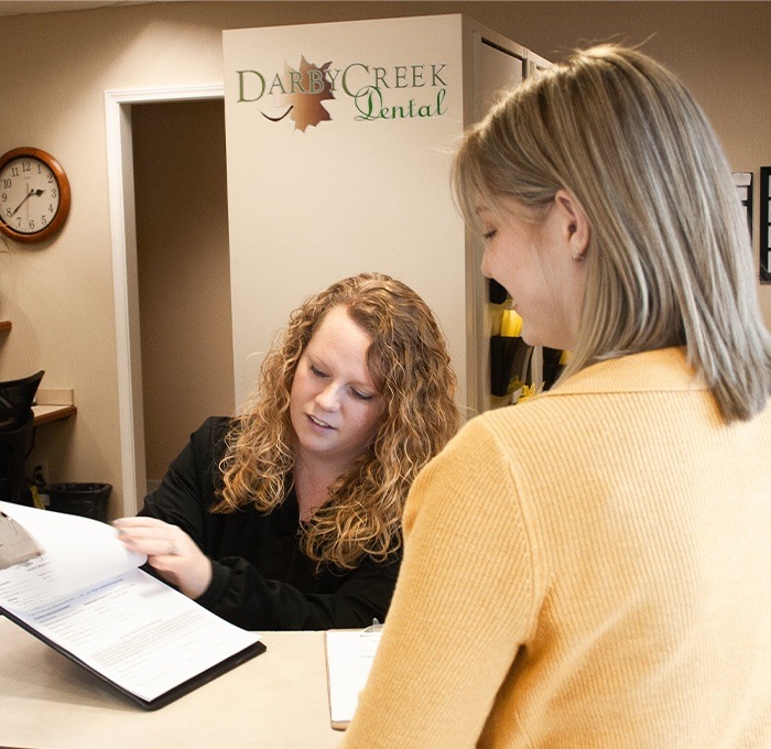 Marysville team member going over dental insurance with patient