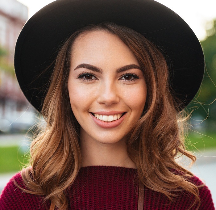 woman with black hat on smiling
