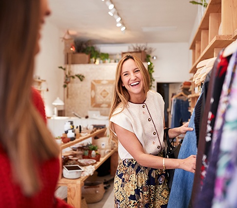 Woman smiling while shopping at clothing store