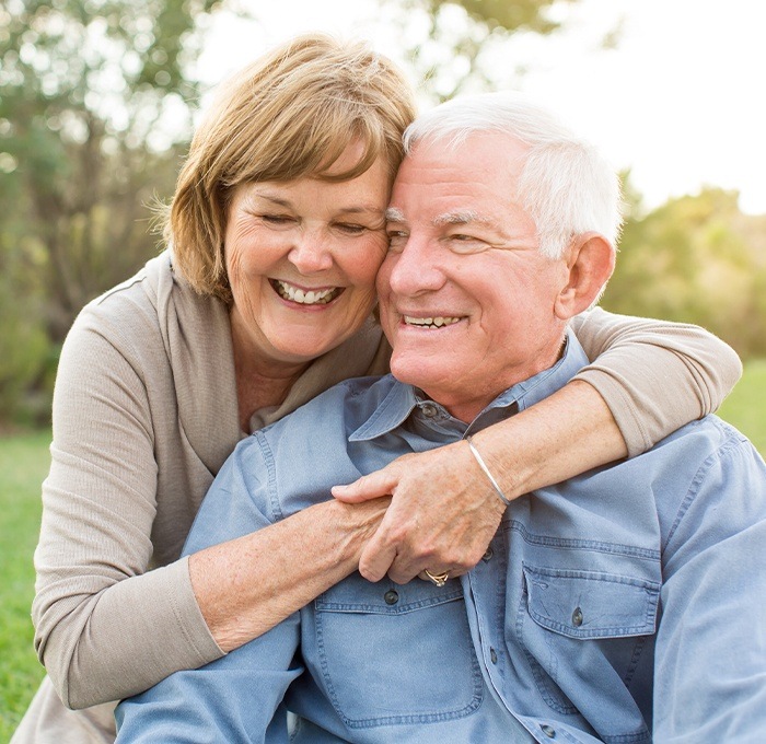 older couple hugging and smiling