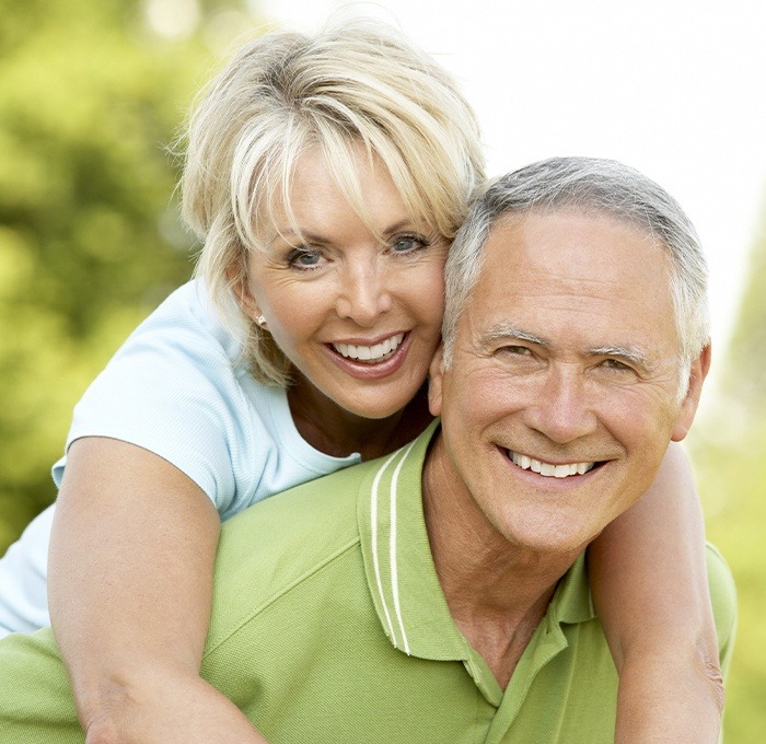 man giving wife piggyback ride