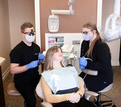 woman getting cleaning from Marysville dentist and assistant