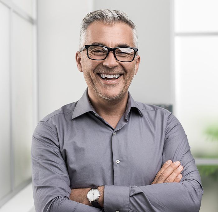 man with thick brim glasses laughing