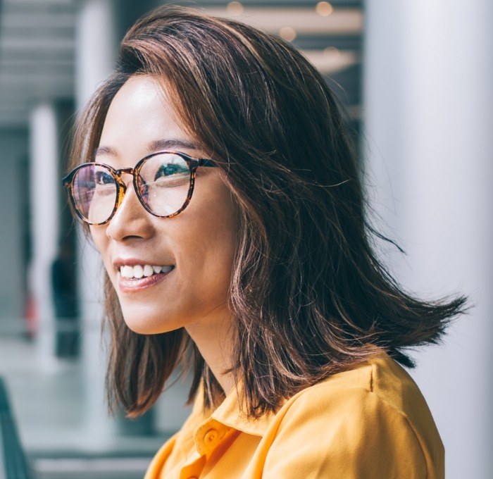 woman with glasses smiling