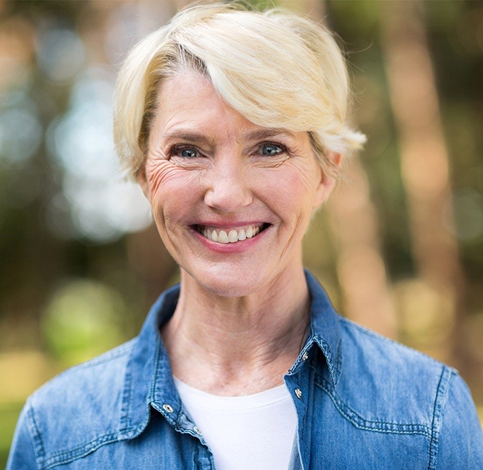 woman with short white hair smiling