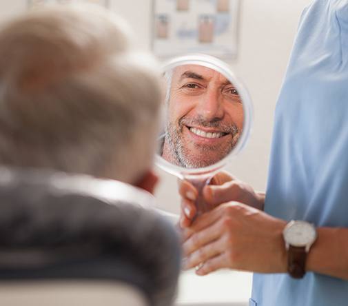 man looking into white circle mirror