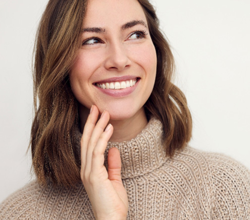 Woman in brown sweater smiling