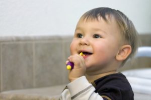 A toddler brushing their teeth.