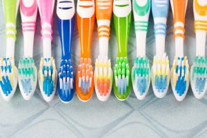 assortment of multi colored toothbrushes