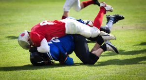 football players in a tackle