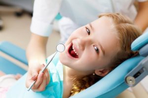 girl smiling dentist chair