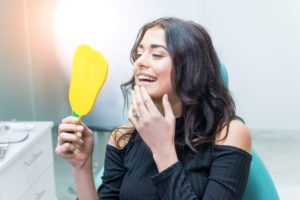 woman looking at smile in mirror