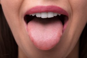 person sticking out their tongue