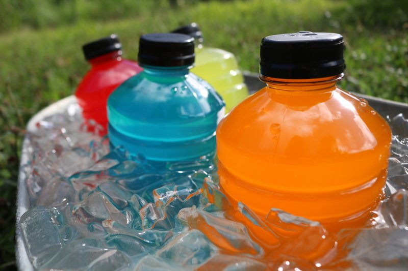 a cooler full of different colored sports drinks