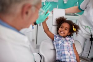 little girl giving her dentist a high-five