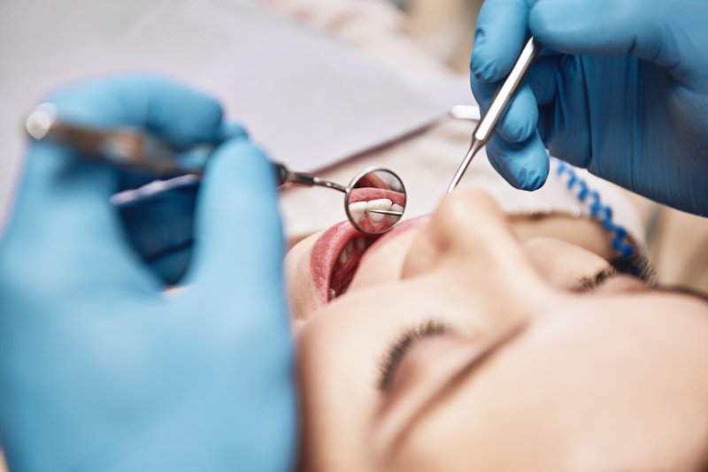 Dentist conducting dental exam at routine visit