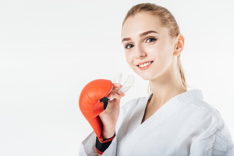 Woman wearing custom sports guard from dentist