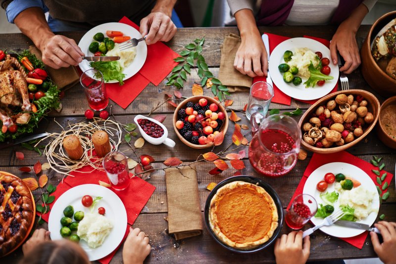 a table full of savory and sugary foods prepared for Thanksgiving