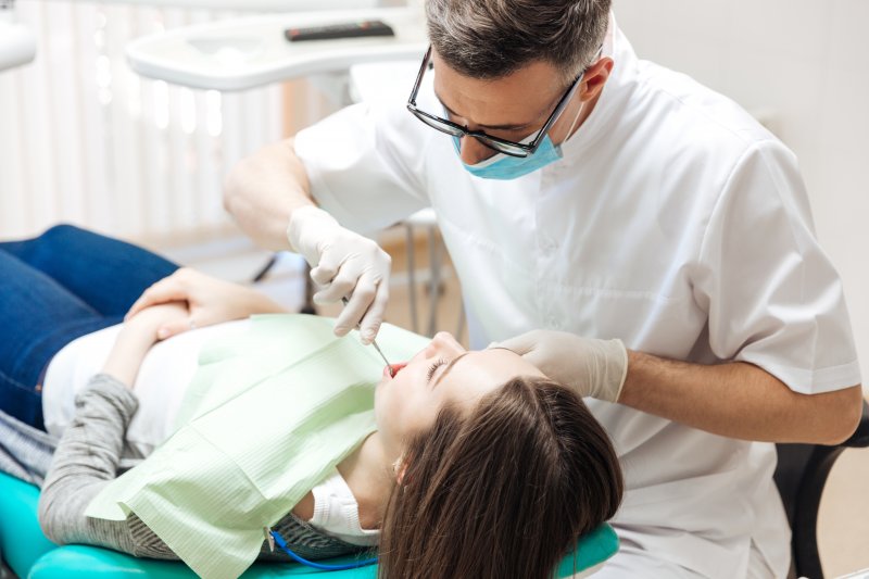 Closeup of dentist conducting routine dental checkup