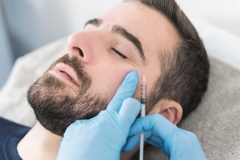 Male patient getting BOTOX injections around his eye