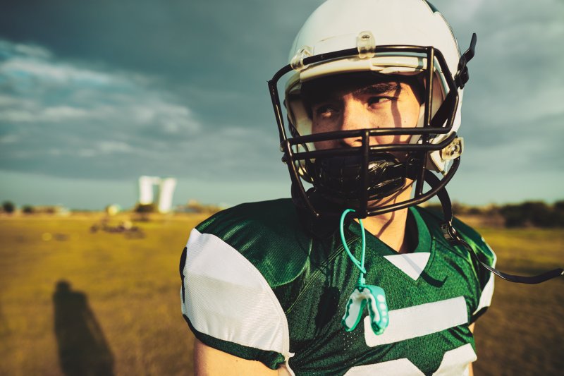 football player with a custom mouthguard 