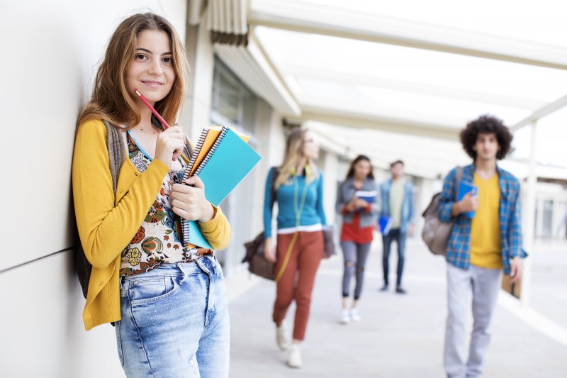 young Invisalign teen in school