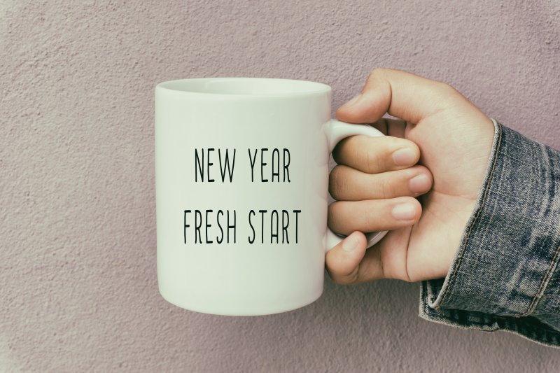 person holding cup for New Year’s resolutions in Marysville