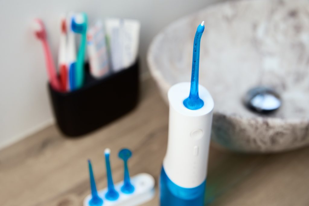 Closeup of Waterpik next to sink