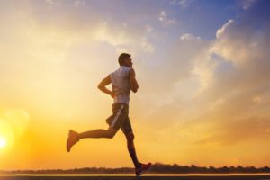 man jogging outside at sunset 