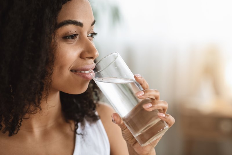Portrait of a smiling woman drinking water