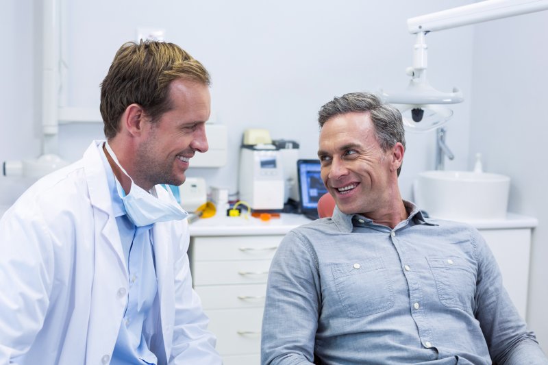 patient speaking to dentist about having tooth extracted