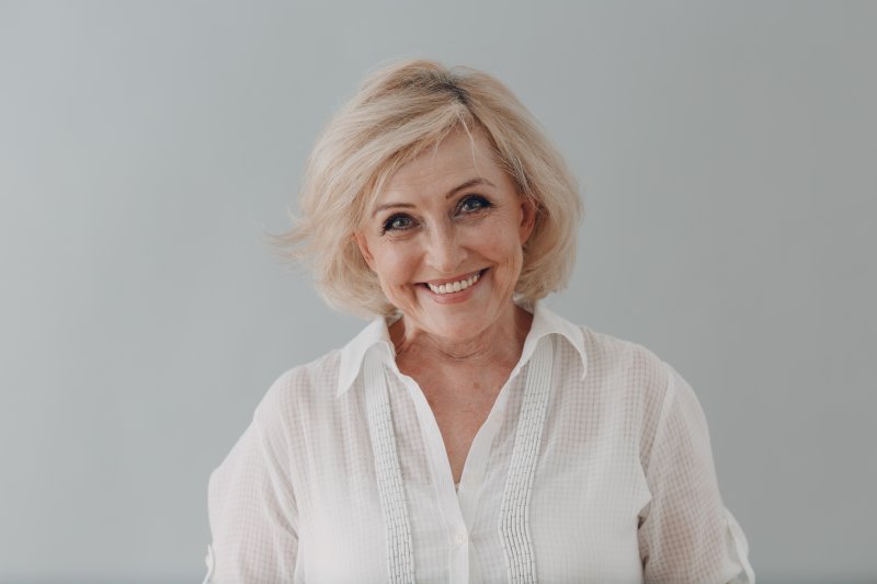 An older woman smiling in her dentures