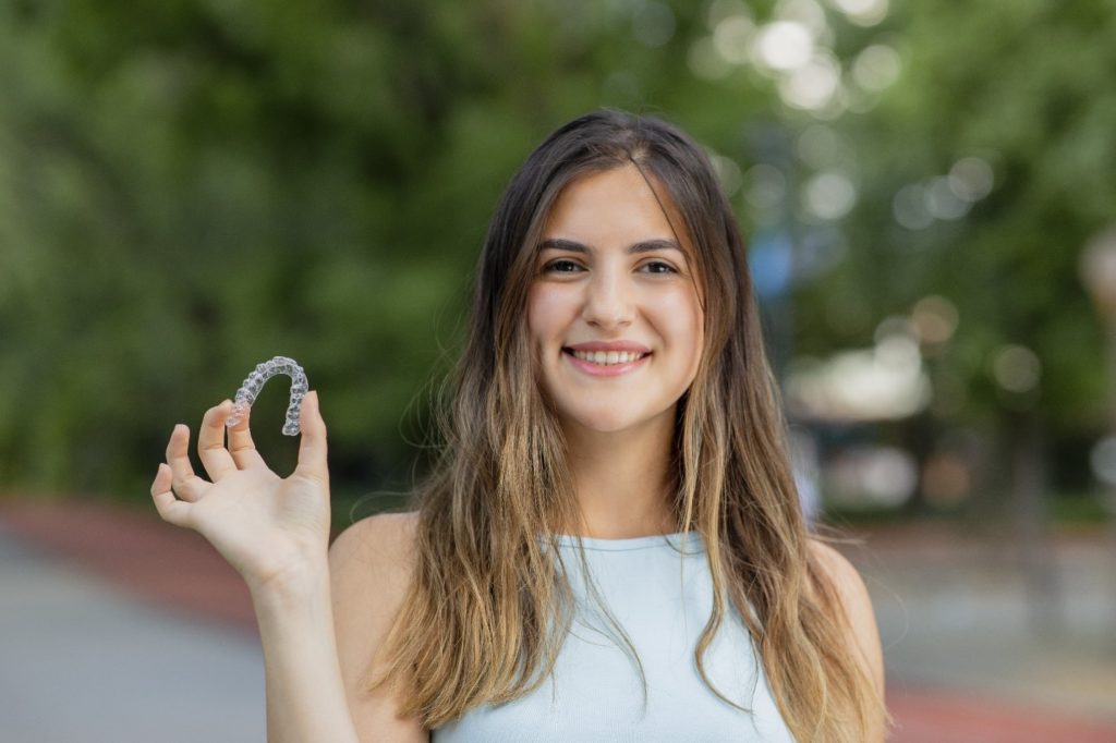 person holding Invisalign